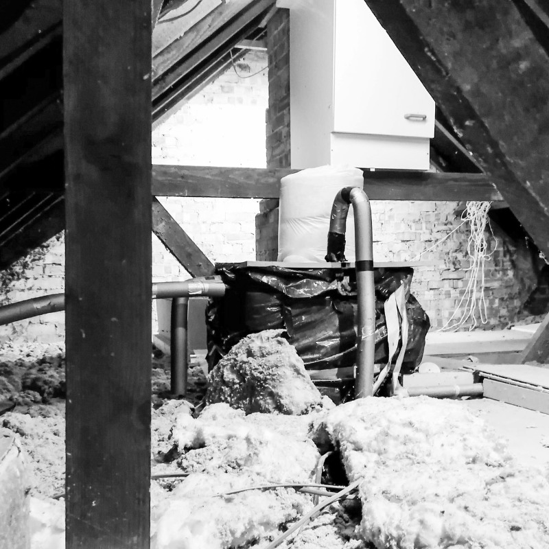 Black and white photo of a old insulation in an attic space.