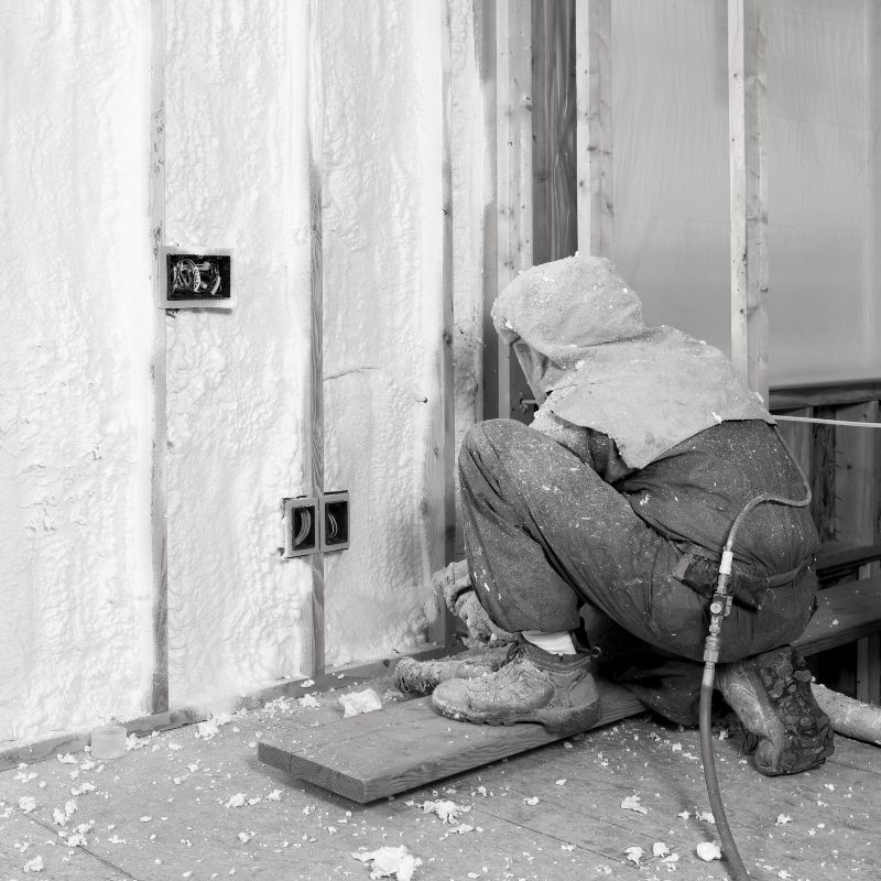 spray-foam-insulation-3 Black and white photo of a person spraying insulation.